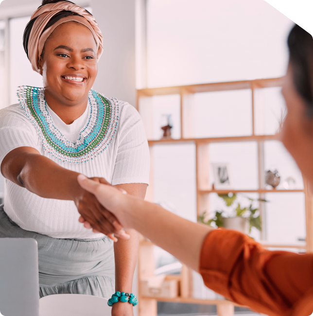 Merchant having a happy handshake with customer