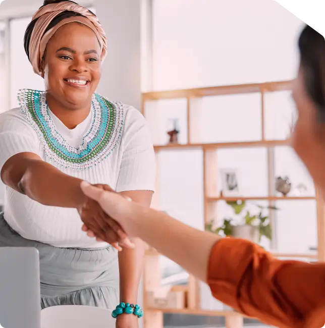 Merchant having a happy handshake with customer