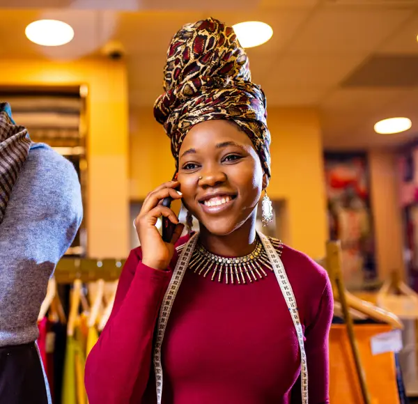 Happy African Lady Making a Phone Call - Dynamic Currency Conversions